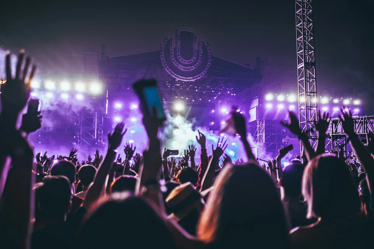 Festival audience gathered in front of a large outdoor concert stage